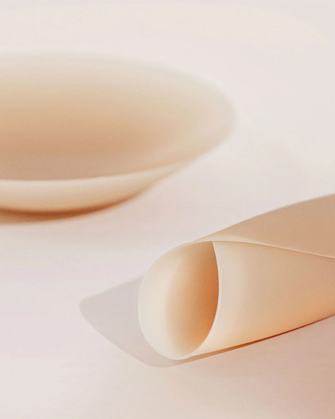 Reusable Velomora silicone nipple covers on a cream background
