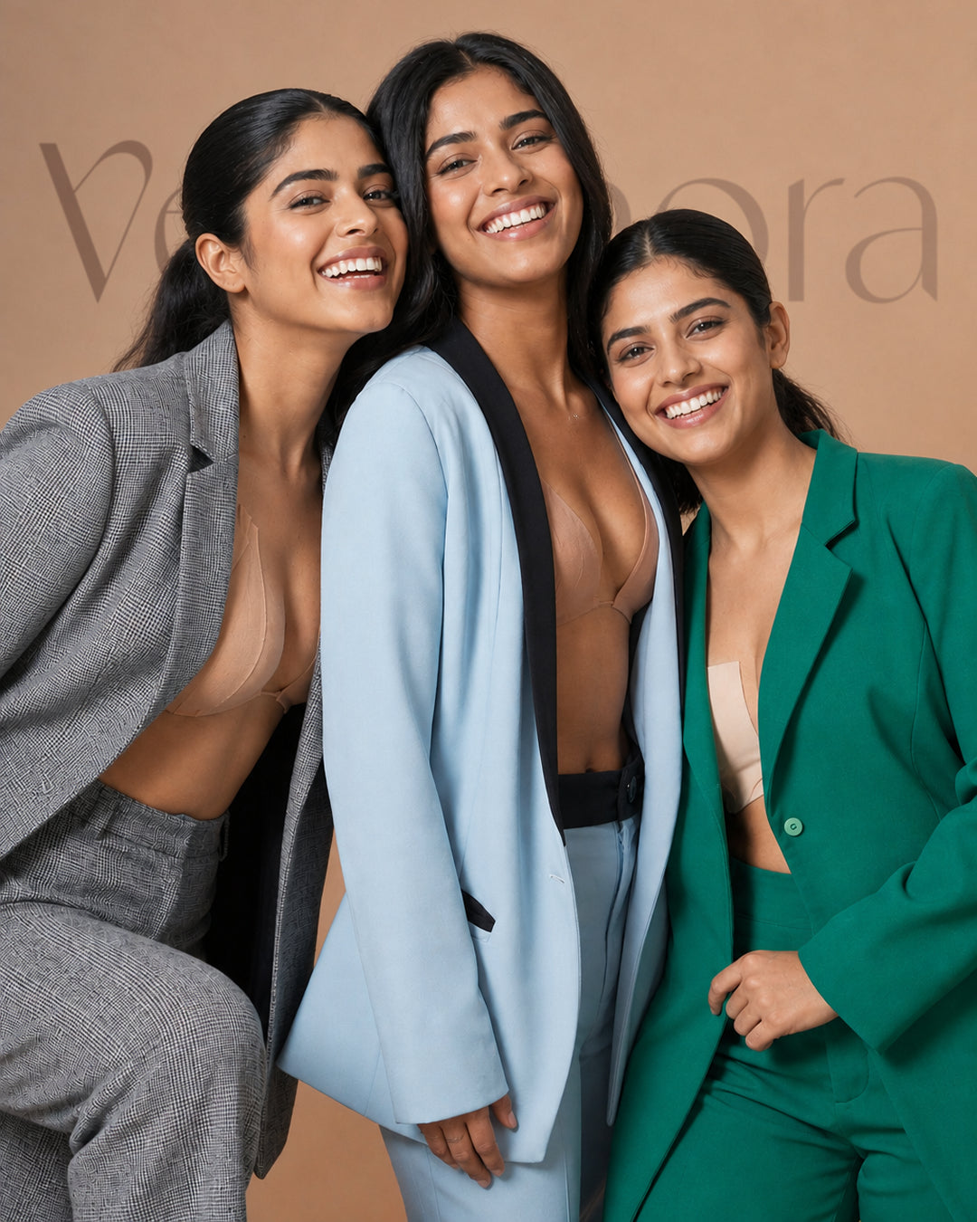 Three women in blazers wearing plunge necklines held with boob tape