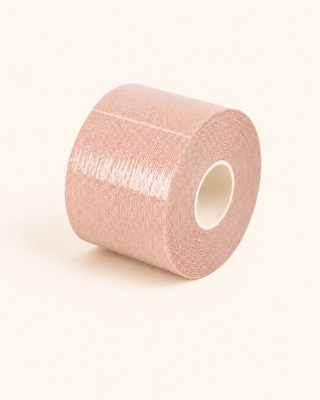 A nude roll of double-sided body tape