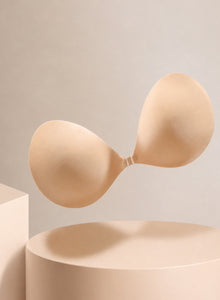 The strapless adhesive bra from the side on a plinth