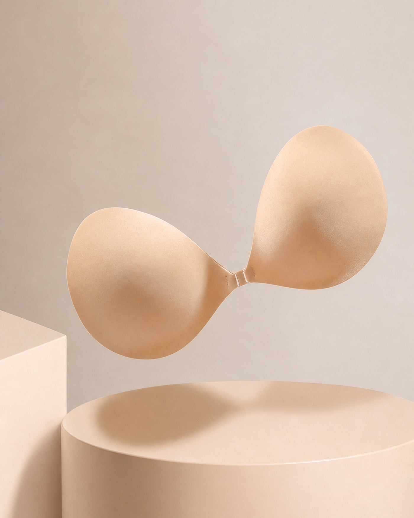 The strapless adhesive bra from the side on a plinth