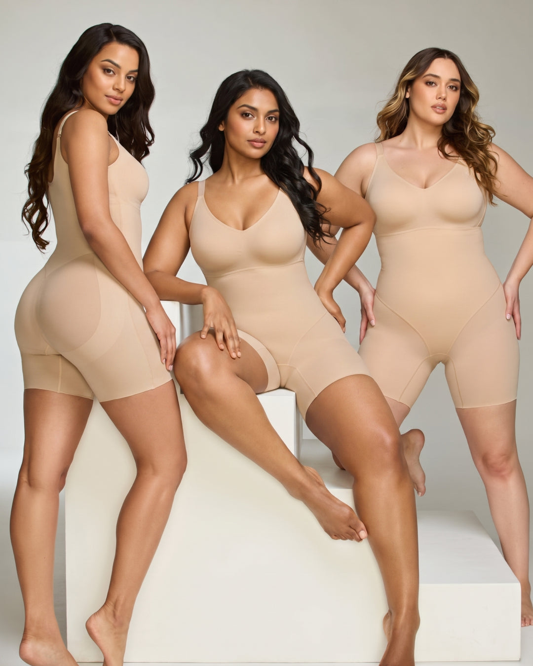 Three women wearing the shapewear bodysuit in different sizes