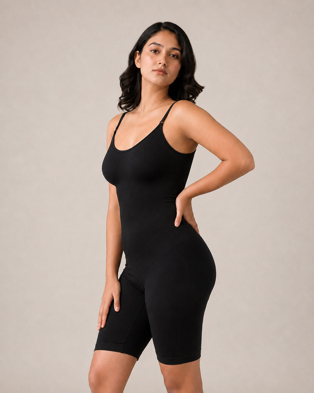 Model in the black shapewear bodysuit, hand on hip